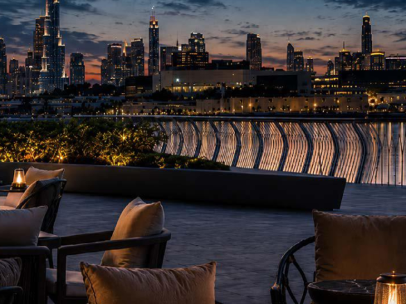 Luxury outdoor terrace seating area of Binghatti Wraith overlooking the Dubai city skyline at night