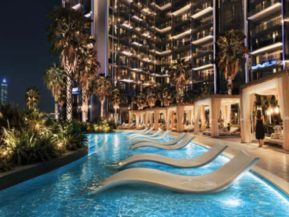 Luxury swimming pool and lounge chairs at Binghatti Wraith Al Jaddaf Dubai at night