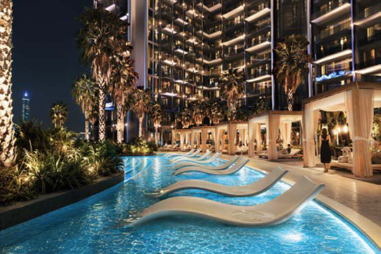 Luxury swimming pool and lounge chairs at Binghatti Wraith Al Jaddaf Dubai at night